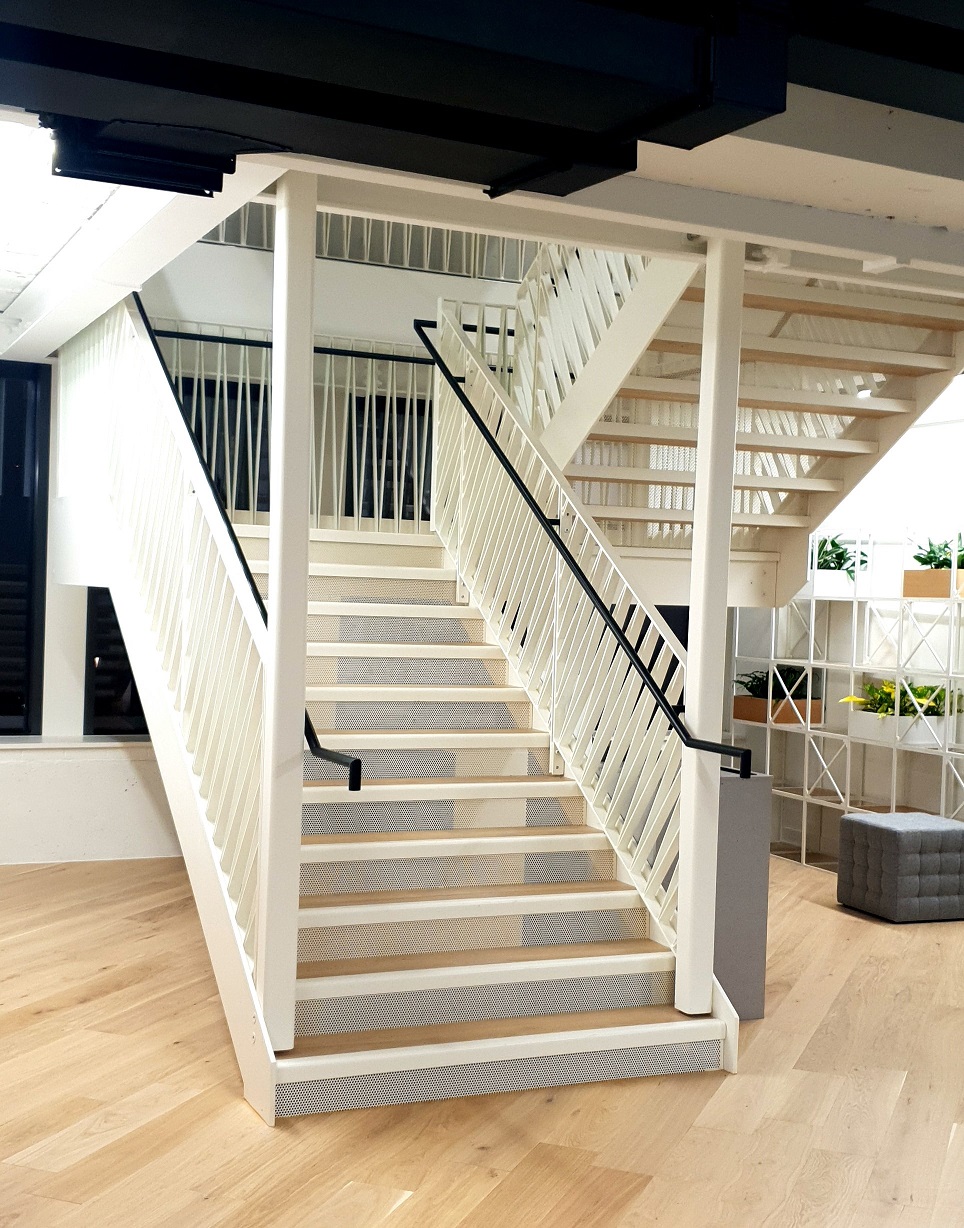 white metal balustrade with black top handrail