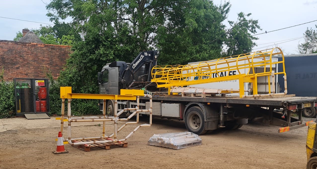 yellow cat ladder transported by truck