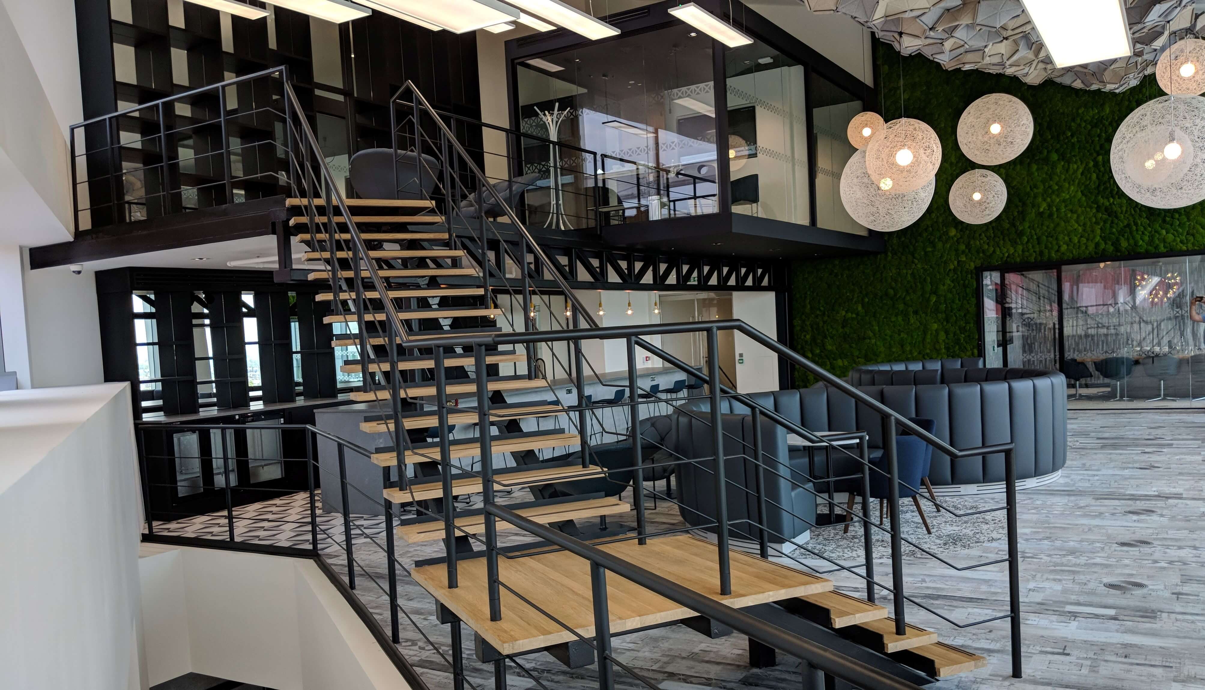 large L shaped staircase black with wood treads
